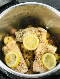 pressure cooked frozen salmon and potatoes in instant pot with lemon on top
