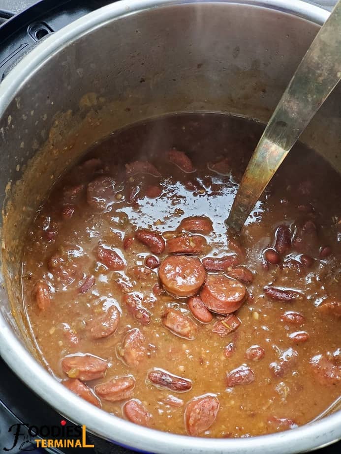 new orleans red beans and rice with sausage in instant pot with a silver ladle