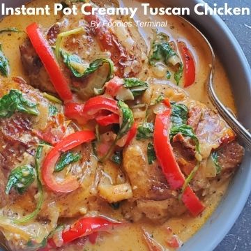 creamy tuscan chicken thighs in a grey bowl