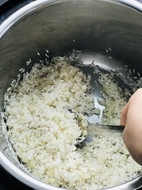 toasting rinsed rice in instant pot with a steel ladle