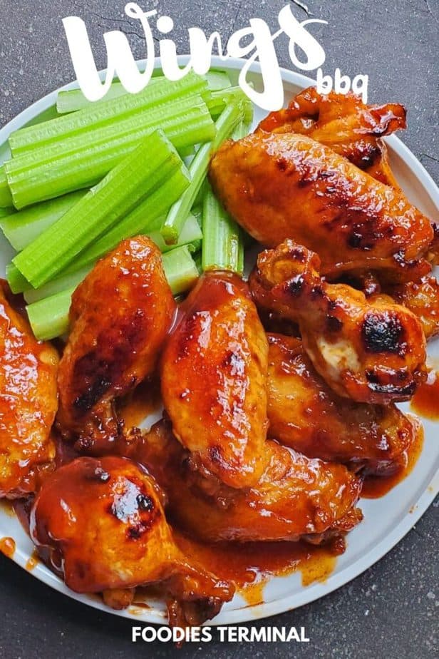 instant pot bbq chicken wings served with celery sticks on a white plate