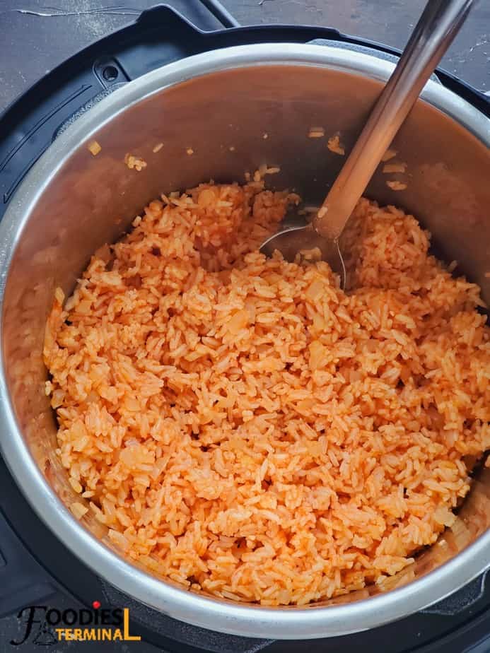 Pressure cooker Mexican rice in instant pot with a steel ladle