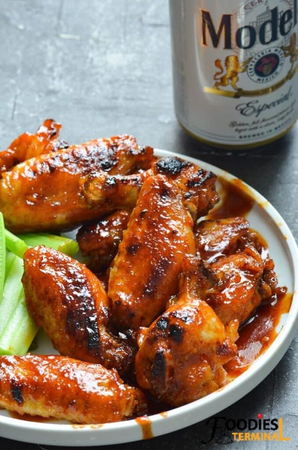 instant pot bbq chicken wings frozen served on a white plate with beer 