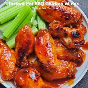 instant pot bbq chicken wings served on a white plate with celery sticks