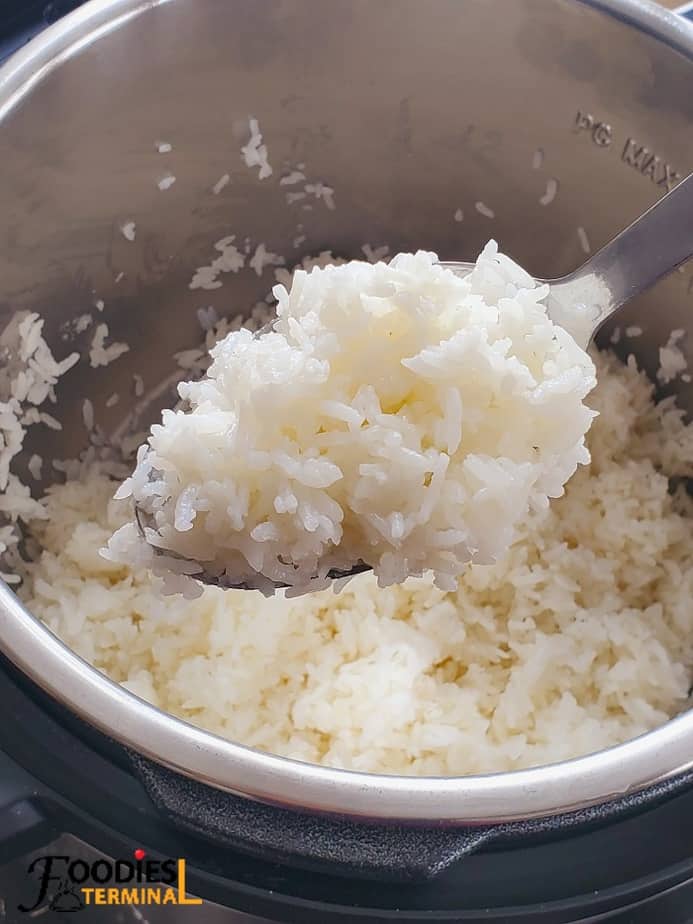 perfect white jasmine rice in instant pot being lifted with a steel ladle