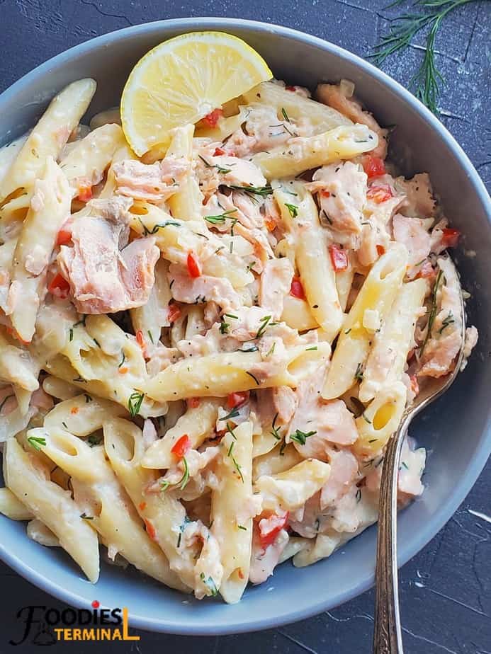 instant pot salmon pasta in a grey bowl with a spoon