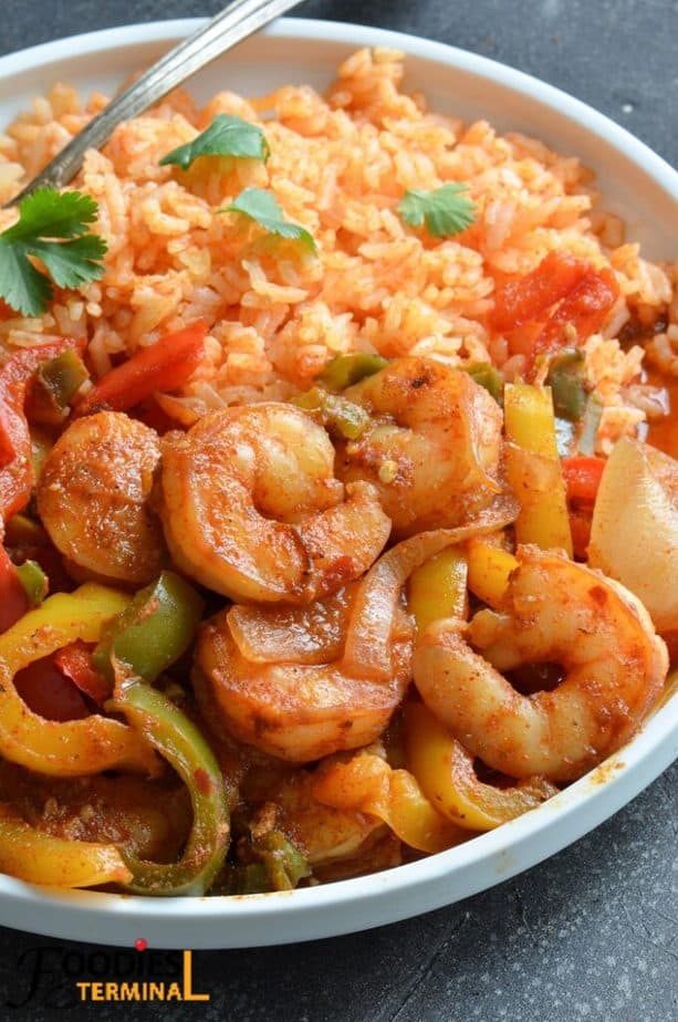 instant pot shrimp fajita with mexican rice in a white plate with a spoon
