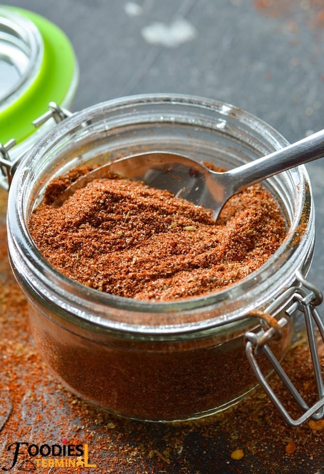 salt free fajita seasoning in a glass container with a spoon