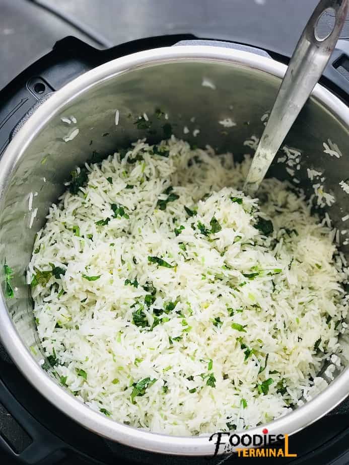lime cilantro rice instant pot recipe with a steel ladle