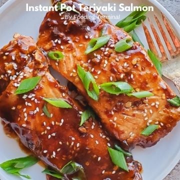 teriyaki salmon in a white plate with a fork