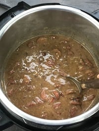 thickened red beans sausage in instant pot with steel ladle