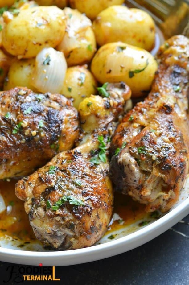 instant pot chicken drumsticks and baby potatoes in a white plate with sauce