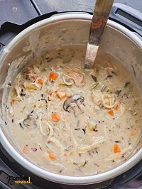 creamy chicken wild rice mushroom soup in instant pot with a steel ladle