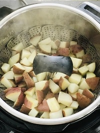pressure cooked potatoes in a steamer basket