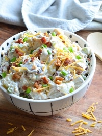 loaded potato salad served in a white bowl