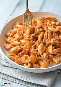 one pot ground turkey pasta in a white plate with a fork