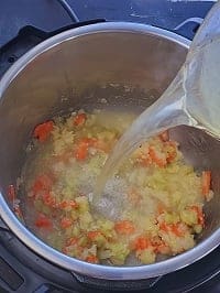 pouring chicken stock