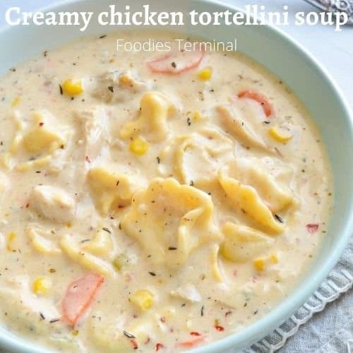 creamy chicken tortellini soup in a light blue bowl