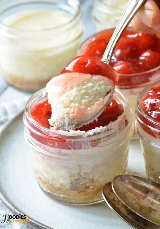 instant pot mini cheesecake in mason jar being scooped with a spoon