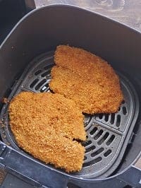 air fried panko parmesan crusted tilapia fillets in the air fryer basket