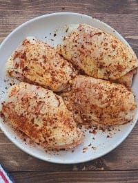 seasoned chicken thighs on a white plate