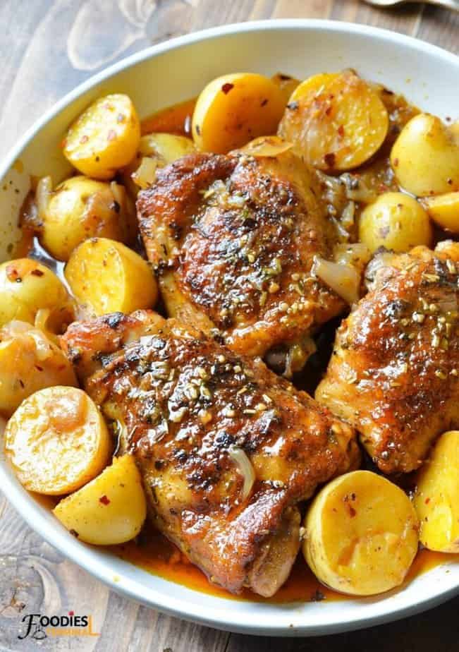 instant pot chicken thighs and potatoes served with gravy on a white plate