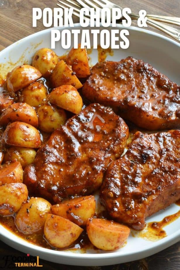 one pan pork chops and potatoes served in a white plate
