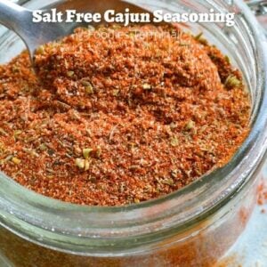 Salt Free cajun seasoning in a glass container with a spoon