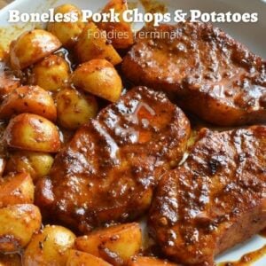 boneless pork chops and potatoes on a white plate