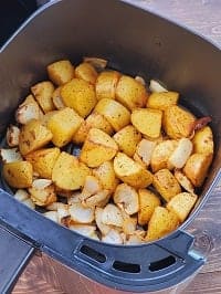 potatoes and onion in air fryer basket