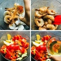 coating shrimp & veggies with seasoning in a clear bowl with a red spatula