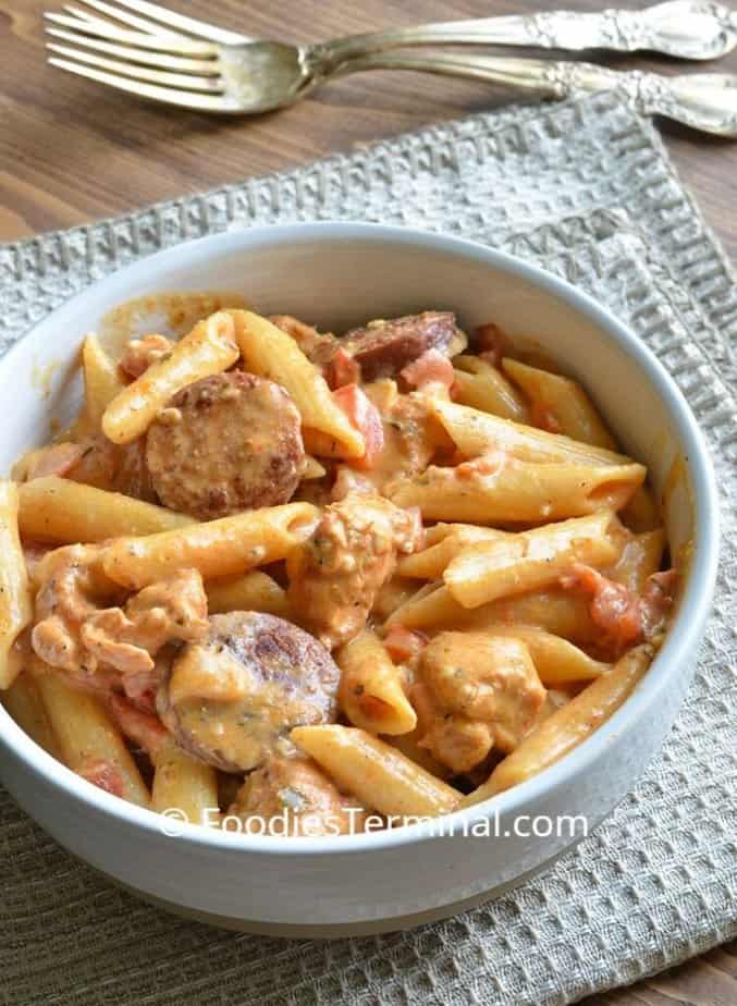 instant pot Cajun chicken pasta in a white bowl with forks in the background