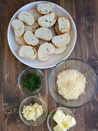 garlic bread ingredients on a brown board