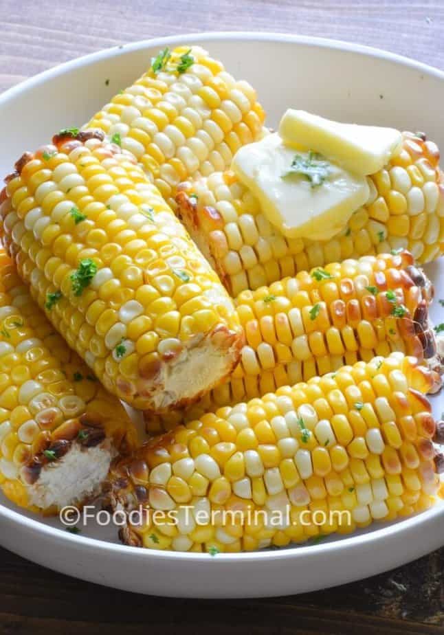 air fryer frozen corn on the cob in a white plate