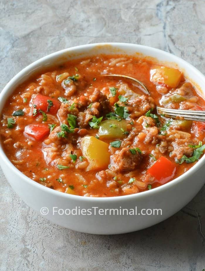 instant pot stuffed pepper soup with sausage in a white bowl with a spoon