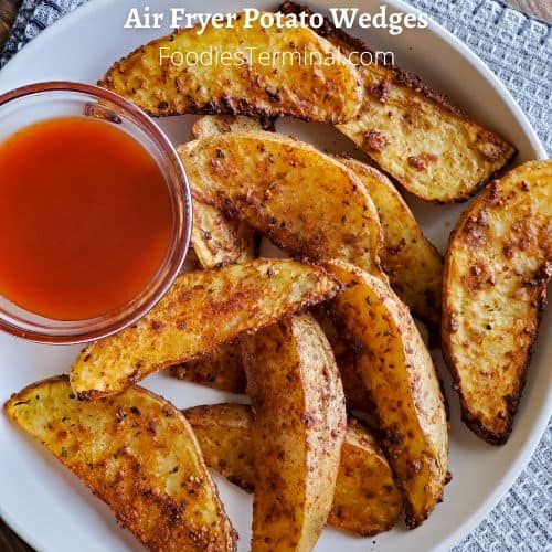 air fryer potato wedges served with ketchup on a white plate