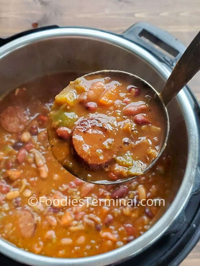 15 bean soup with sausage in a ladle