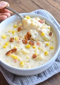 corn chowder in a white bowl with a spoon