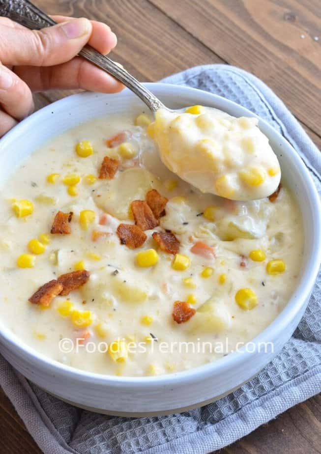 potato corn chowder in a white bowl with a spoon 