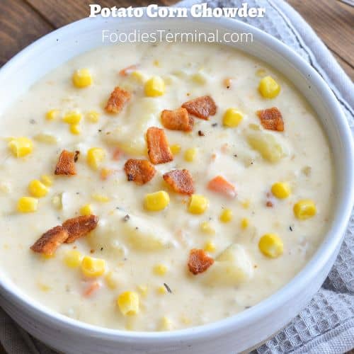 potato corn chowder garnished with bacon bits in a white bowl