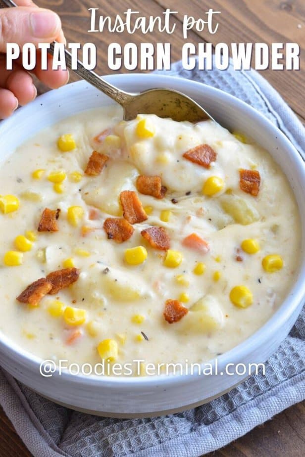 summer corn chowder with potato and bacon in a bowl being scooped with a spoon
