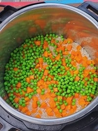 cooked rice and carrots and peas