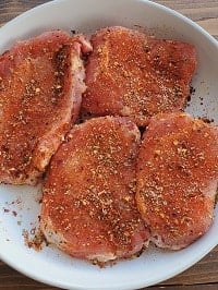 seasoned pork chops in a white plate
