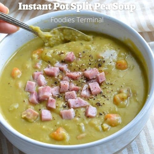 instant pot split pea soup in a white bowl with a spoon & garnished with diced ham