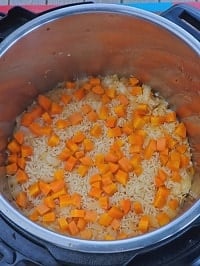 cooked rice with carrots on top
