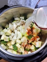pouring stock over diced zucchini in instant pot