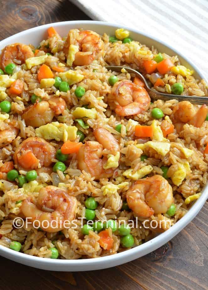 authentic shrimp fried rice recipe in a white plate with a spoon