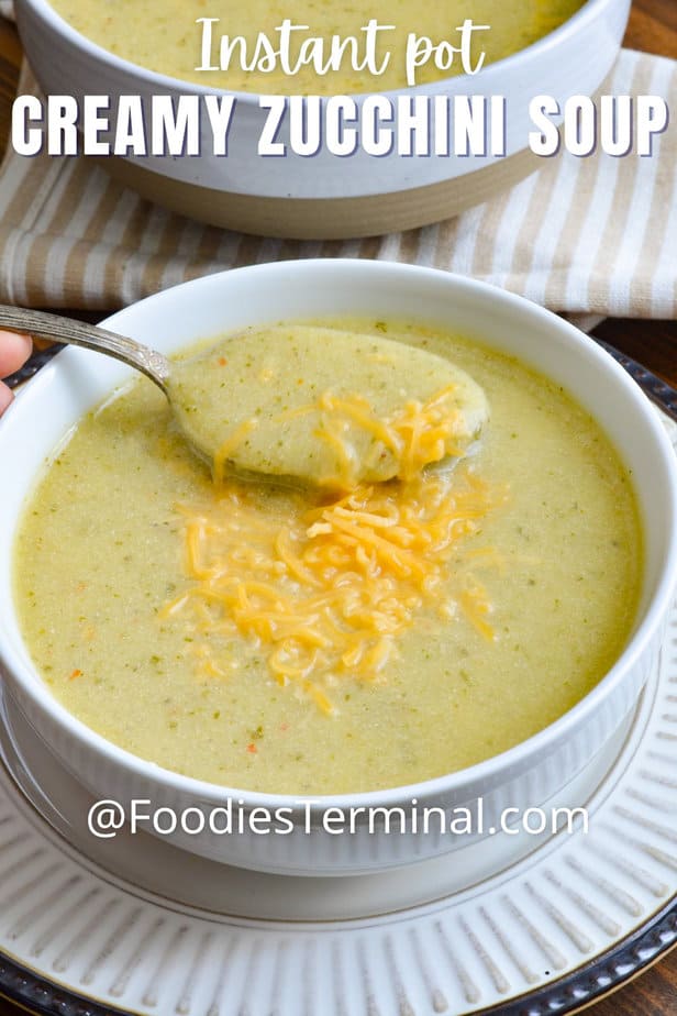 creamy zucchini soup being scooped with a spoon from a white bowl