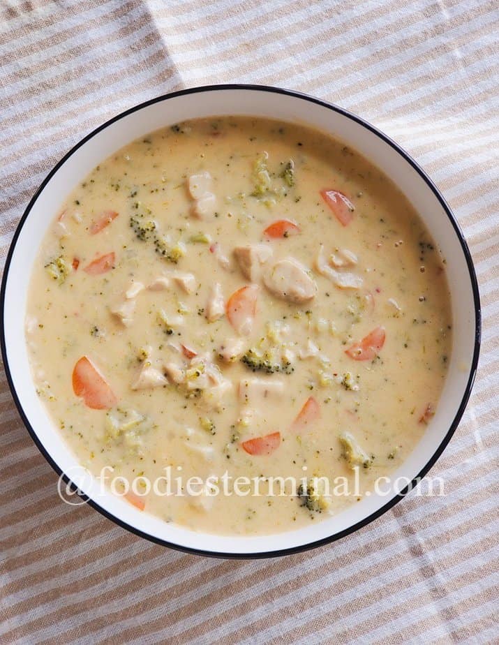 chicken broccoli soup in a white bowl with black rim