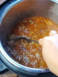 deglazing pot with a steel ladle